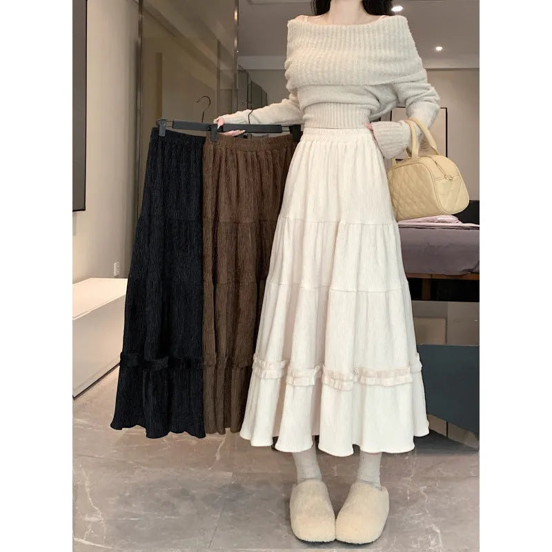 Korean style beige corduroy A-line midi skirt with an elastic waistband on a hanger.