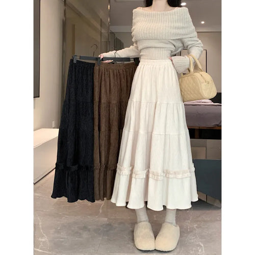 Korean style beige corduroy A-line midi skirt with an elastic waistband on a hanger.