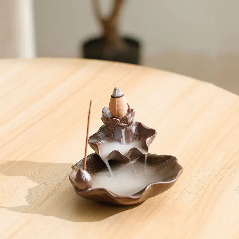 Purple clay ceramic reverse flow incense burner with lotus and plum blossom motifs