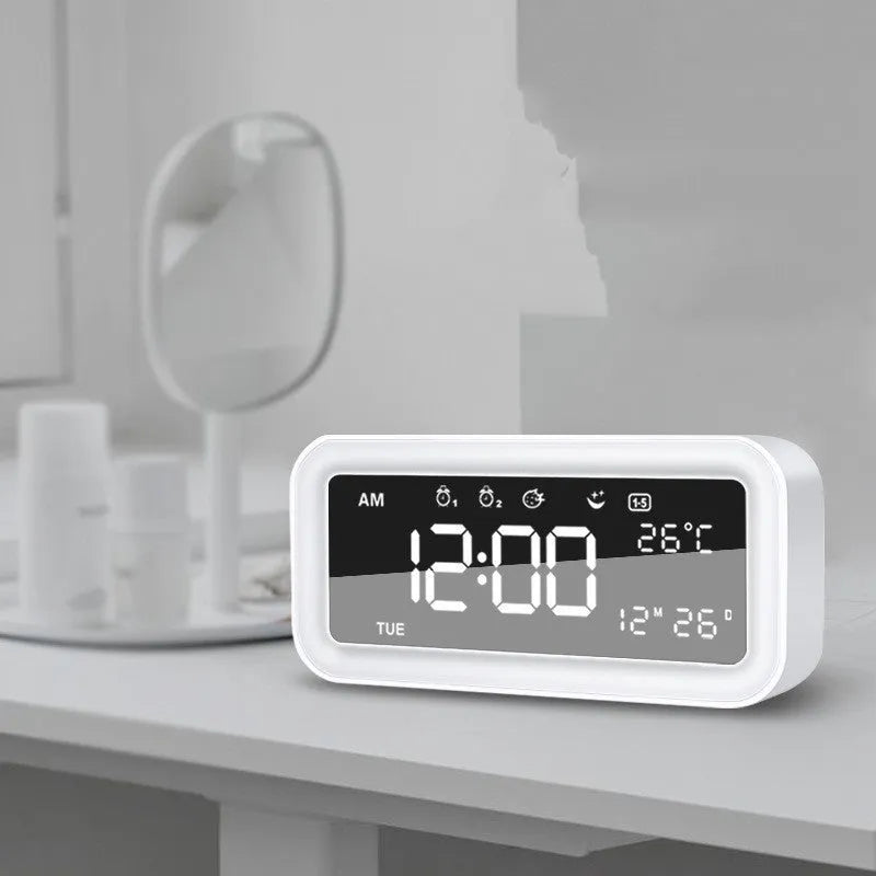 Blue rectangular LED atmosphere alarm clock with digital display on a desk.