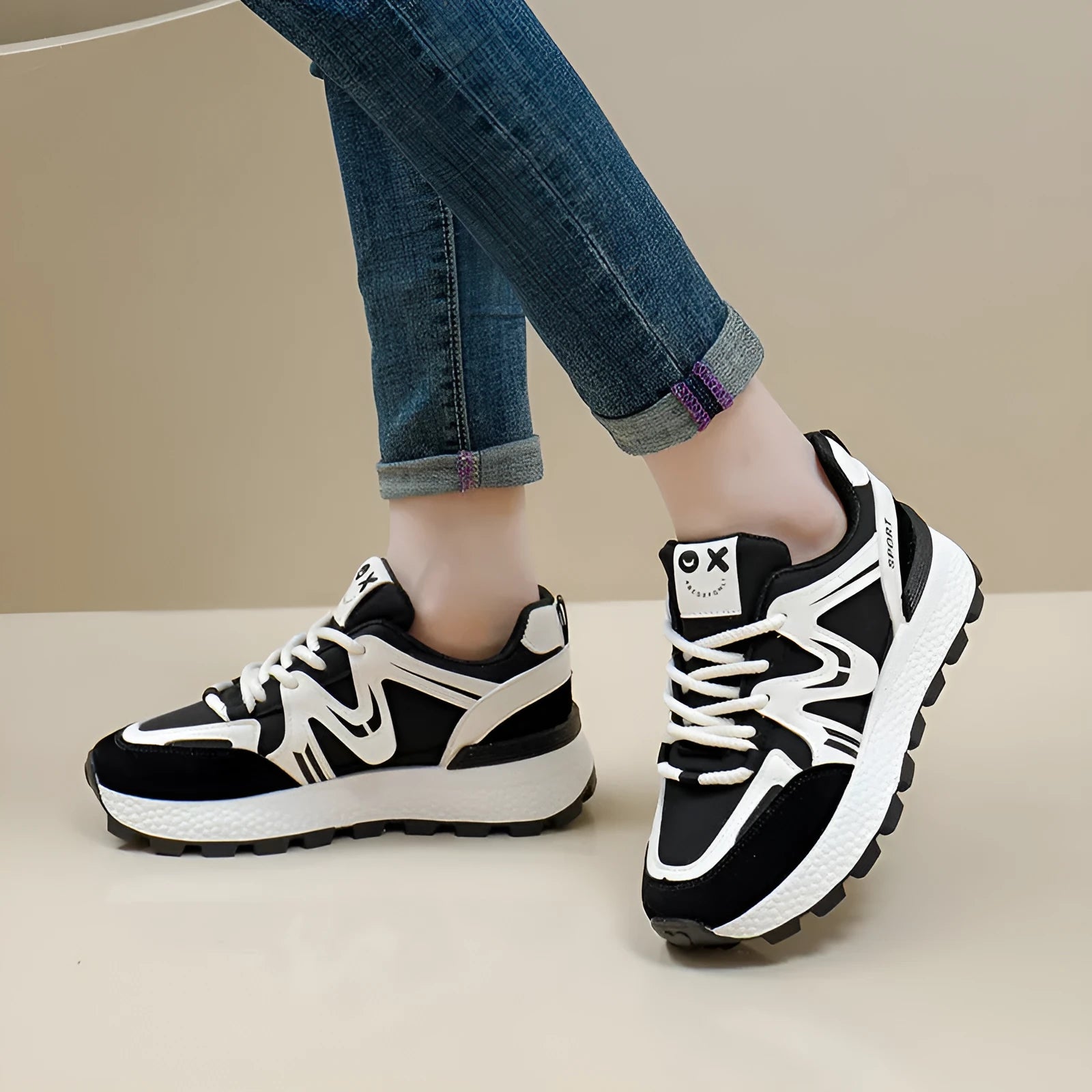 Women's black platform casual lace-up trainers with a round toe and flat heel on a white background.