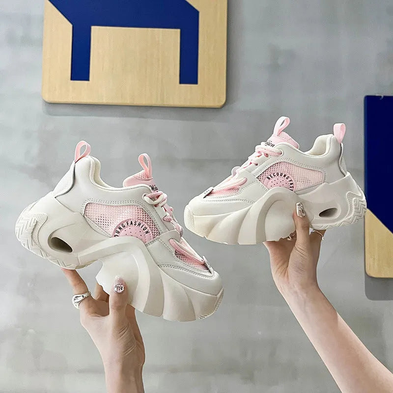 Women's pink thick sole sneakers with cross straps and breathable mesh lining on a white background.