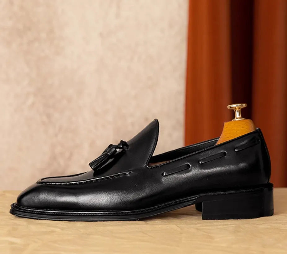 Men's black genuine leather loafers with fringed detail, rubber sole, and slip-on design