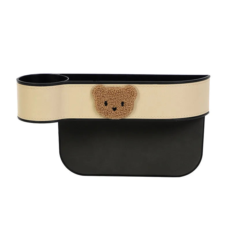 Leather car seat gap storage box with cartoon bear design for organising phones and keys.