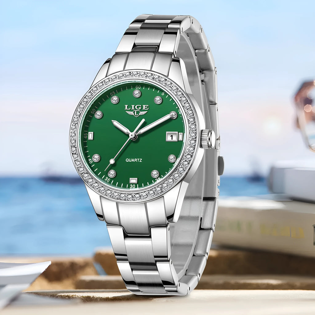 Women's silver fashion quartz watch with diamond bezel, luminous hands on a coloured dial, showing side profile with spiral crown.