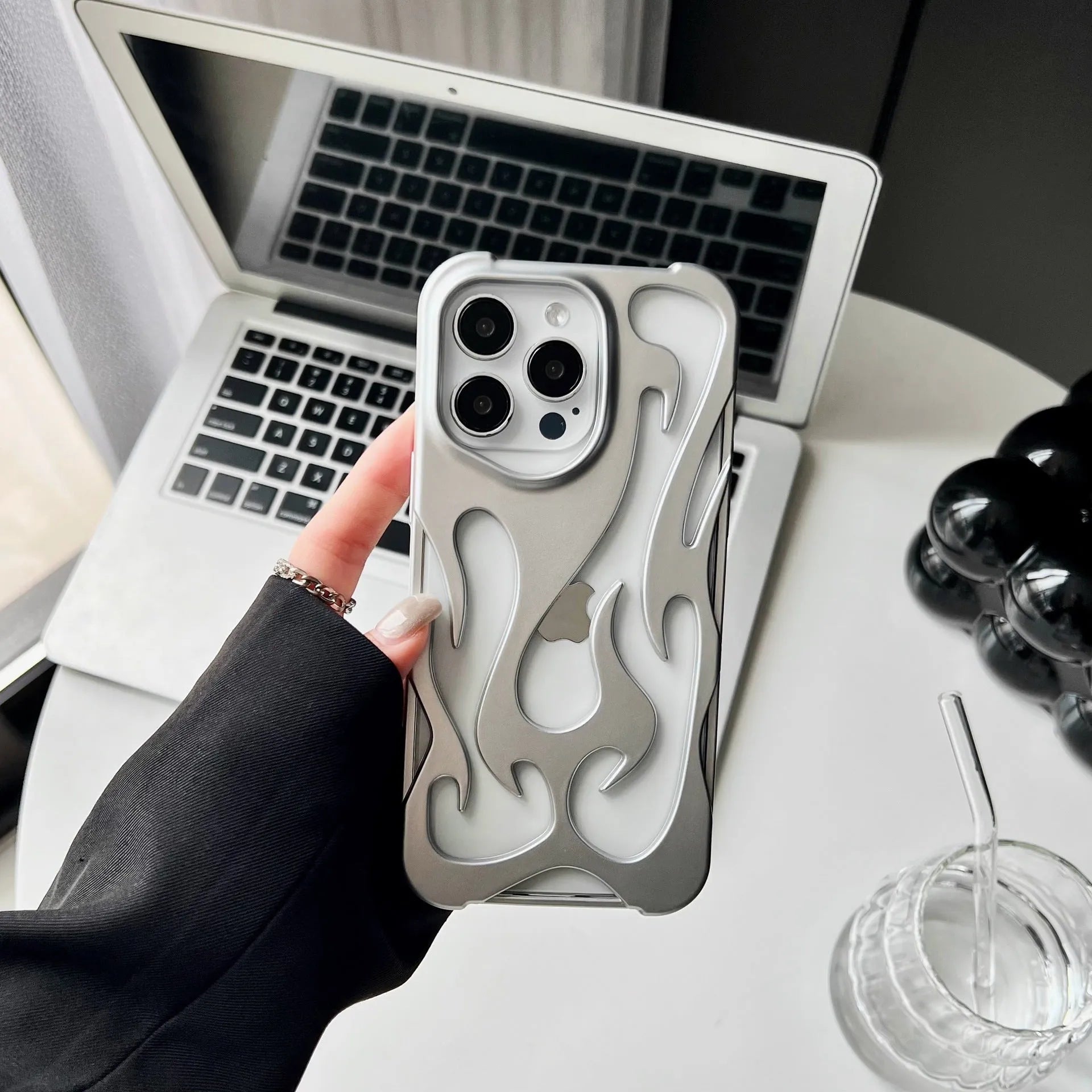 Electroplated iPhone case with hollow flame pattern design in gold, black, purple, and silver finishes