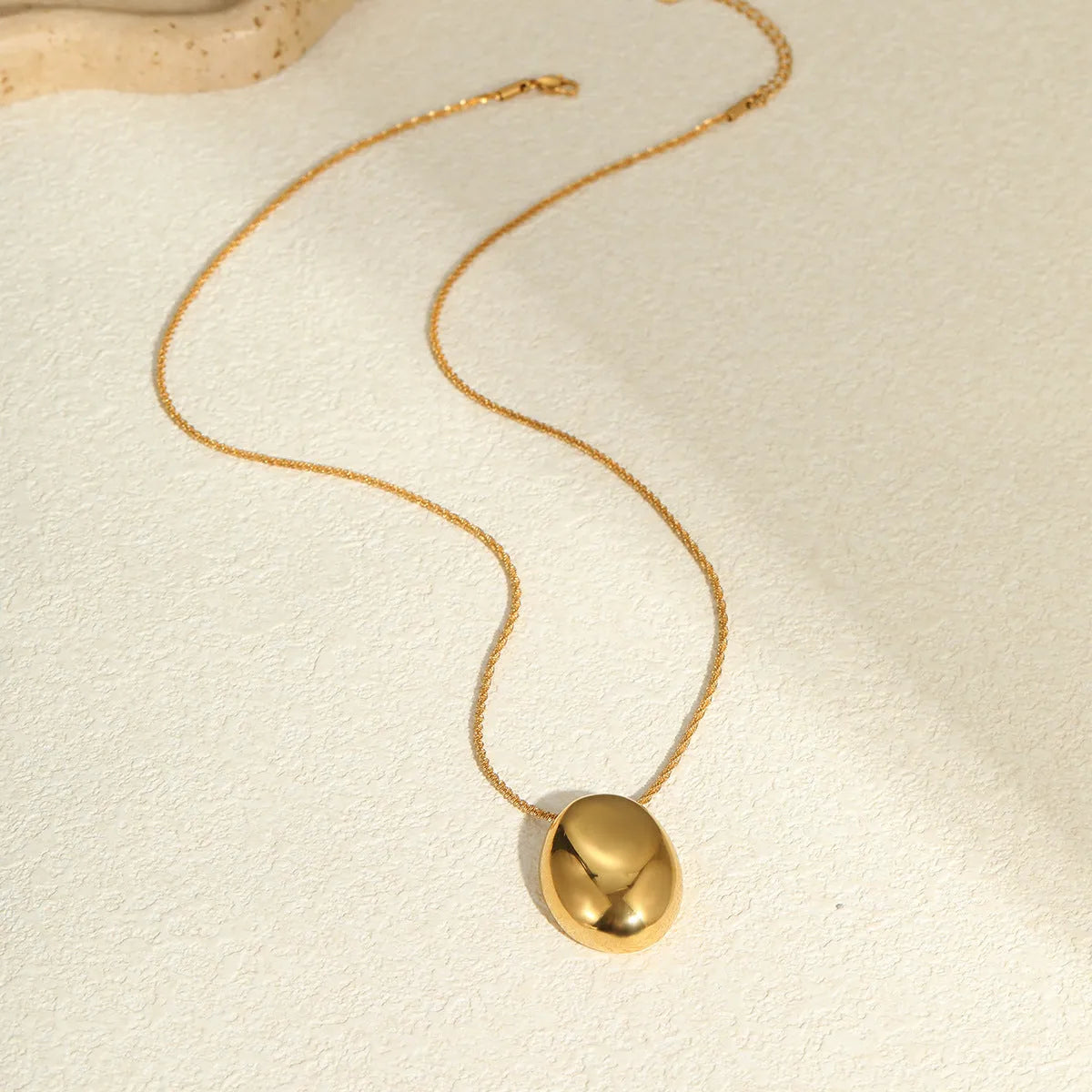 Gold geometric pendant necklace with 41-50cm chain on stainless steel background