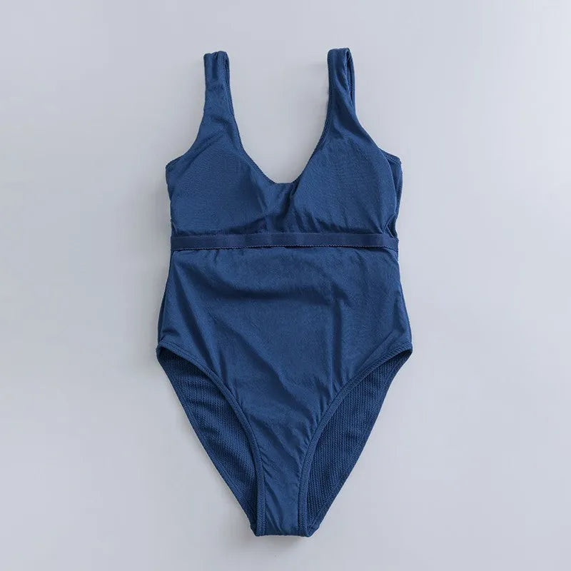 Navy blue women's one-piece slim swimsuit with triangle design and chest pad