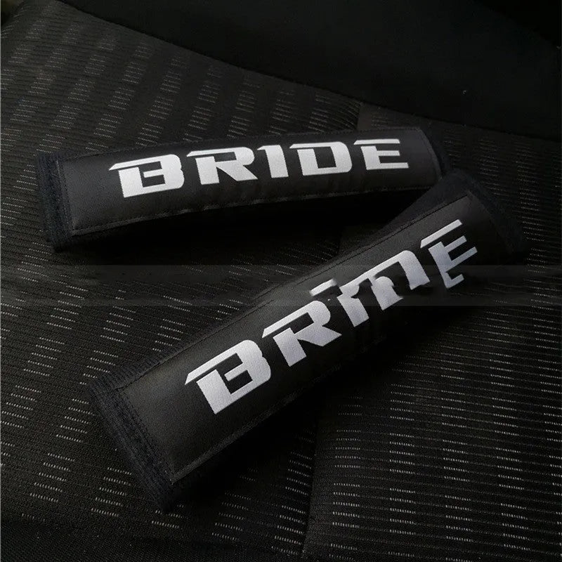 Car seatbelt shoulder pads with embroidery detail in black, blue, and red colour options