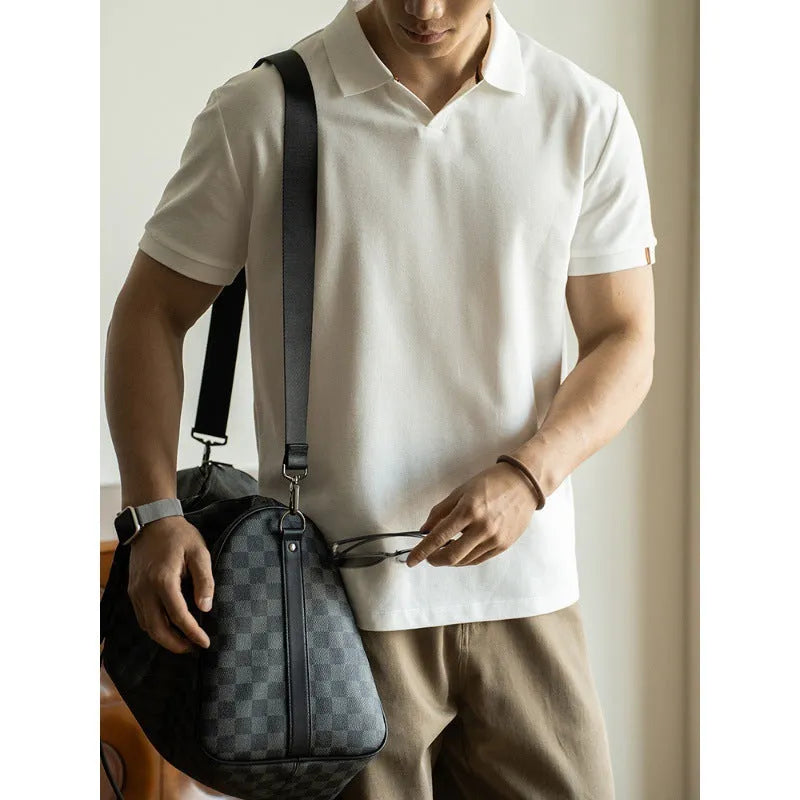 Man's short-sleeve blue polo shirt on a hanger, showing the classic collar and button placket.