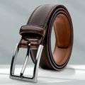 Men's brown genuine leather belt with 95 grain texture and metal alloy buckle laid flat.