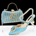 Women's black high-heel shoe and matching clutch bag set with floral drill buckle and ankle chain decoration