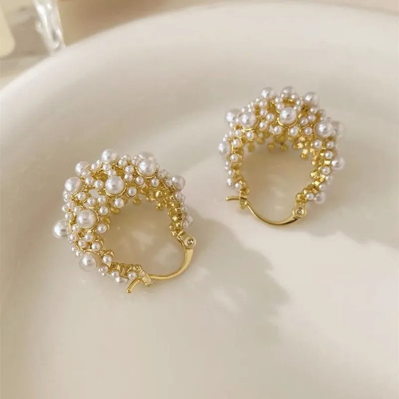 Gold-coloured copper flower basket earrings with pearl inlay and small rice-shaped bead detailing