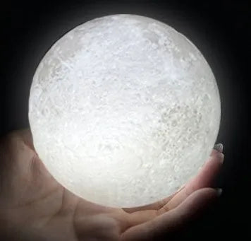 3D printed white moon lamp with textured surface on a wooden stand, showing touch ring at base.