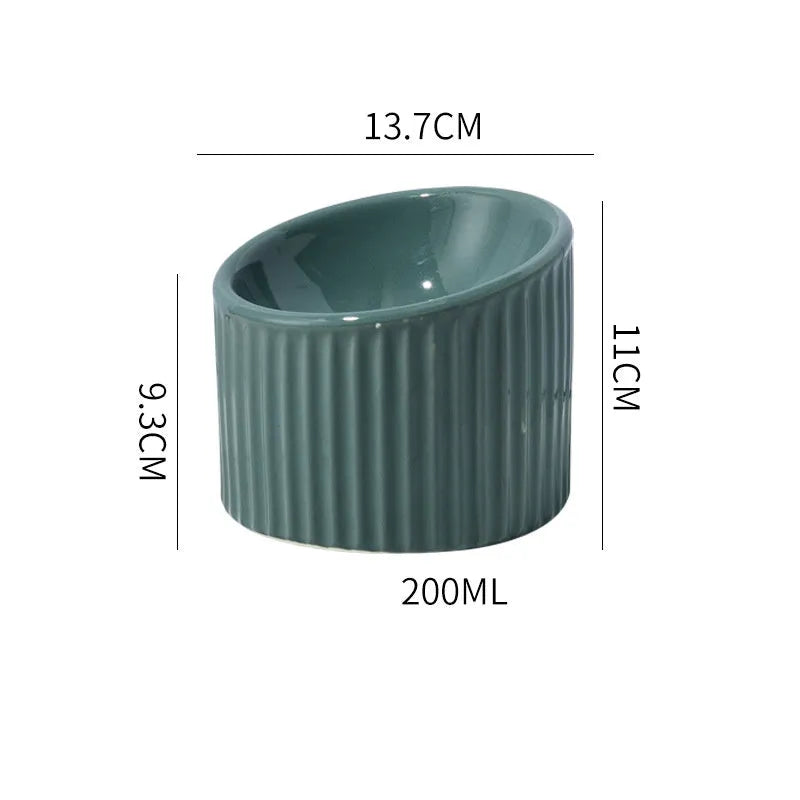 Elevated ceramic cat bowl in green colour showing raised, tilted design for food or water.