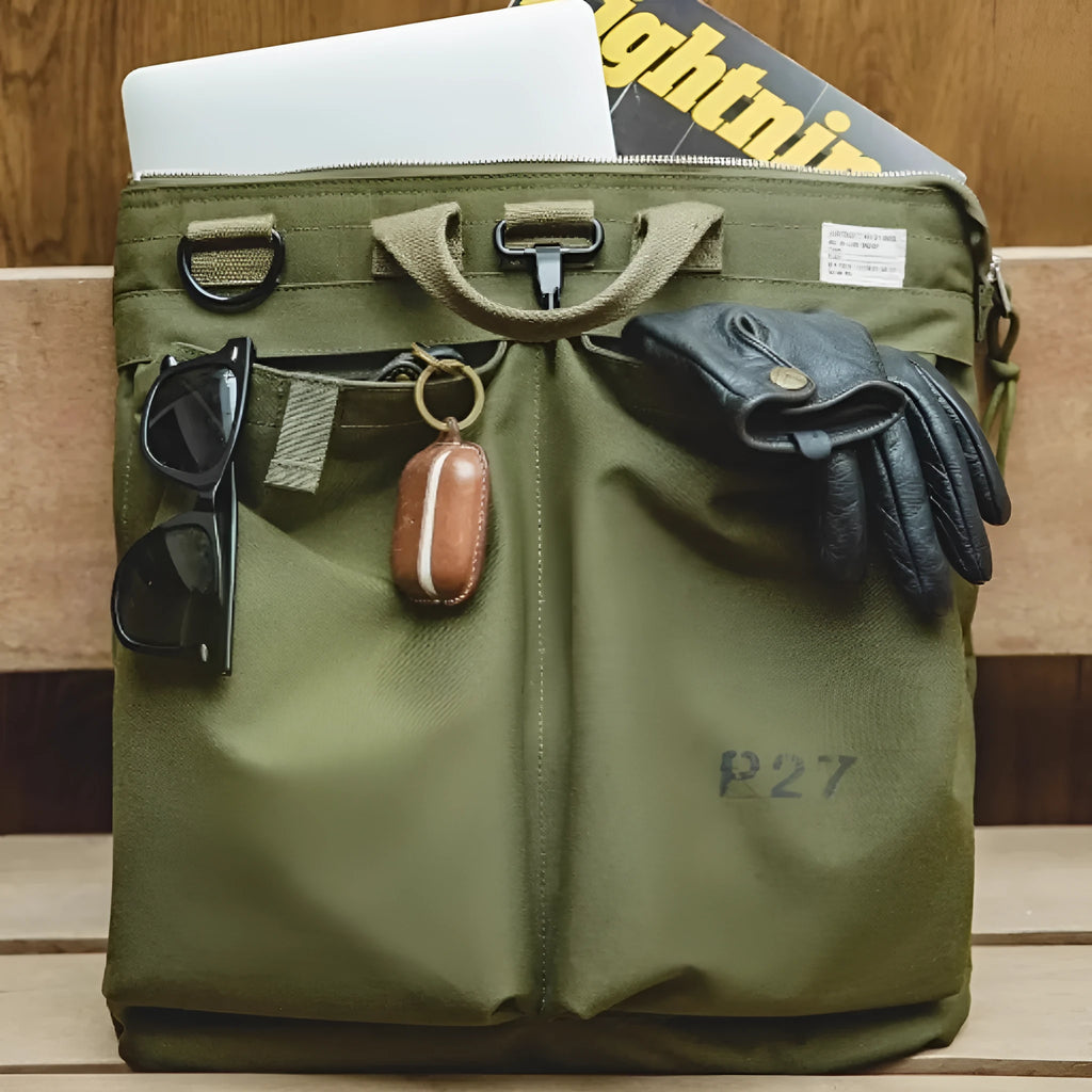 Canvas crossbody messenger bag in military green with shoulder strap and hard handle showing laptop compartment