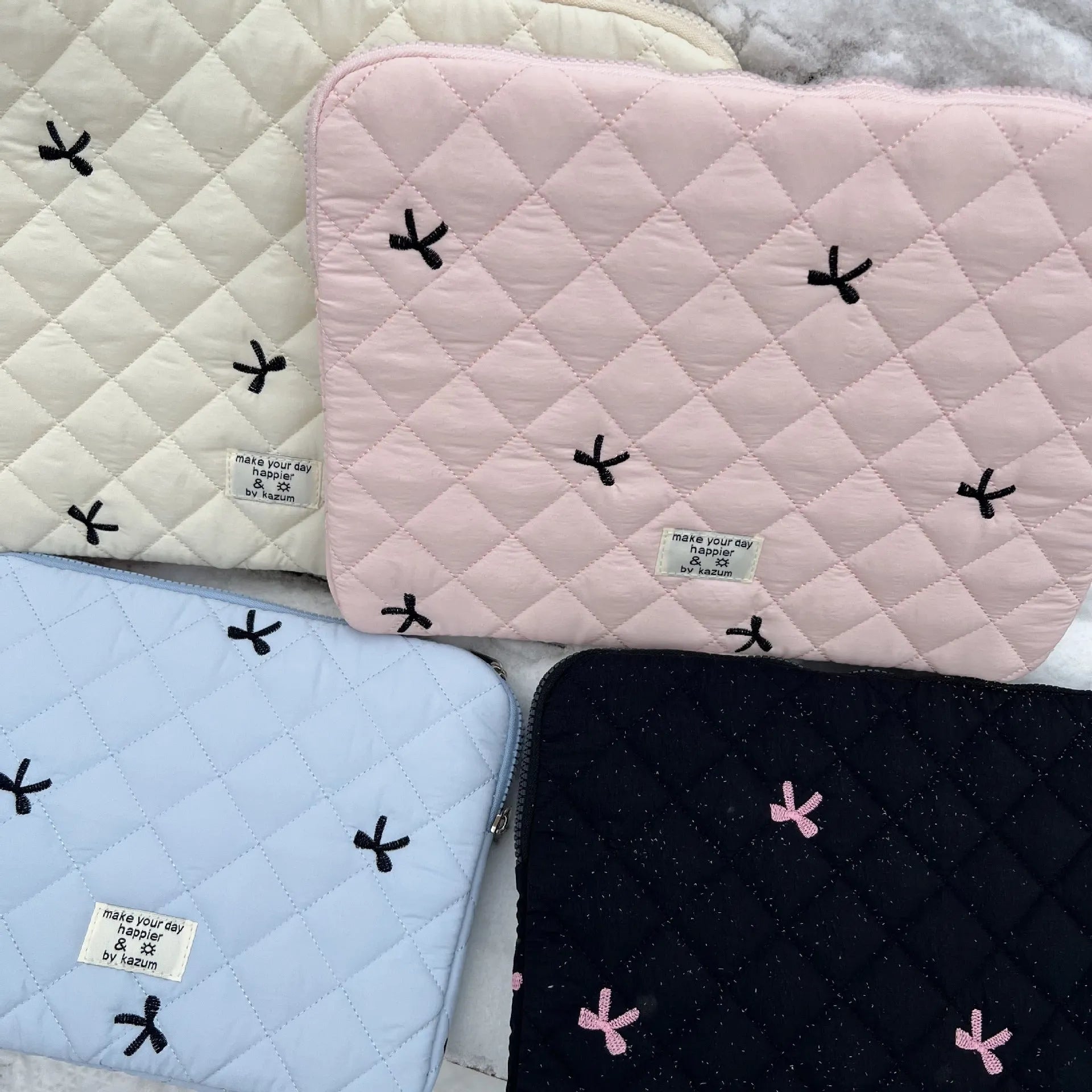 Nylon laptop storage bag with rhombus embroidery and bow in light blue, showing front detail