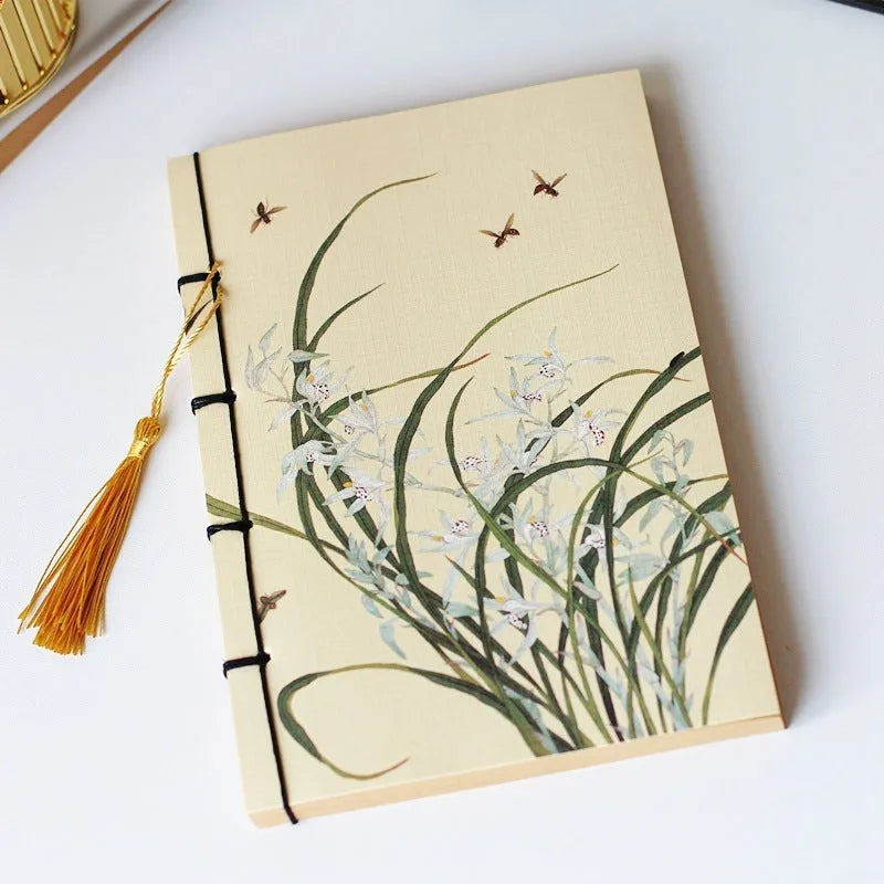 A5 antique wire-bound notebook with retro painting cover, thread binding, and black tassels.