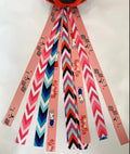 Decorative ribbon streamer for a child's ski or skating helmet in various colour options.