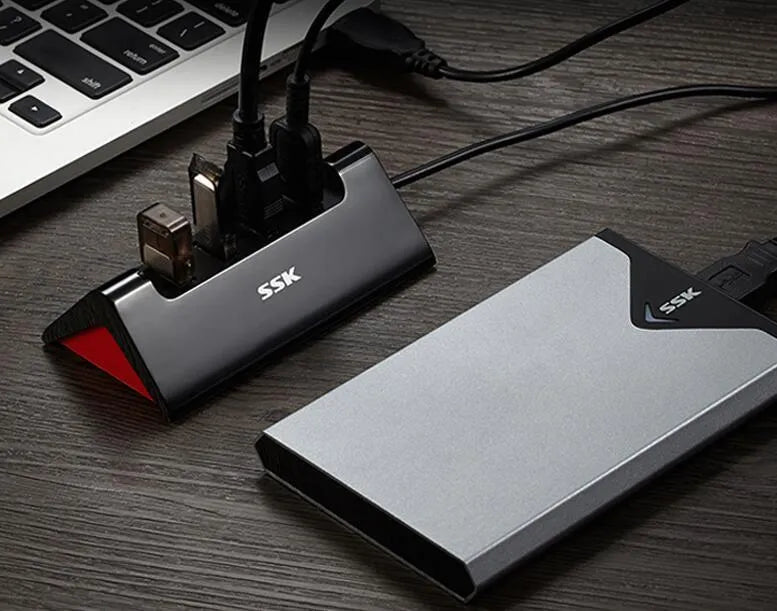 Black ABS plastic USB expansion hub with 4 ports and a Micro USB power port, shown with a connecting cable.