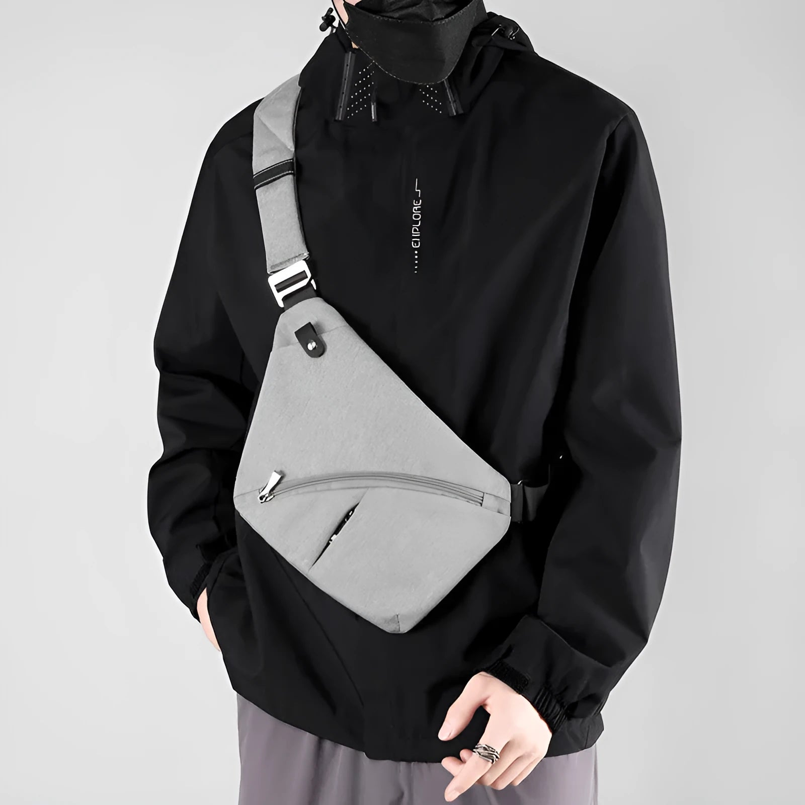 Grey men's oxford cloth chest bag with letter detail, worn on the shoulder.