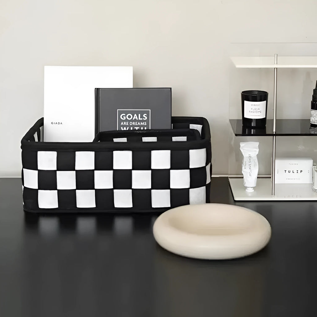 Grey and black checkerboard woven felt folding storage box with collapsible sides.