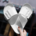 Women's grey blue buckle flip flop sandals with EVA sole on neutral background