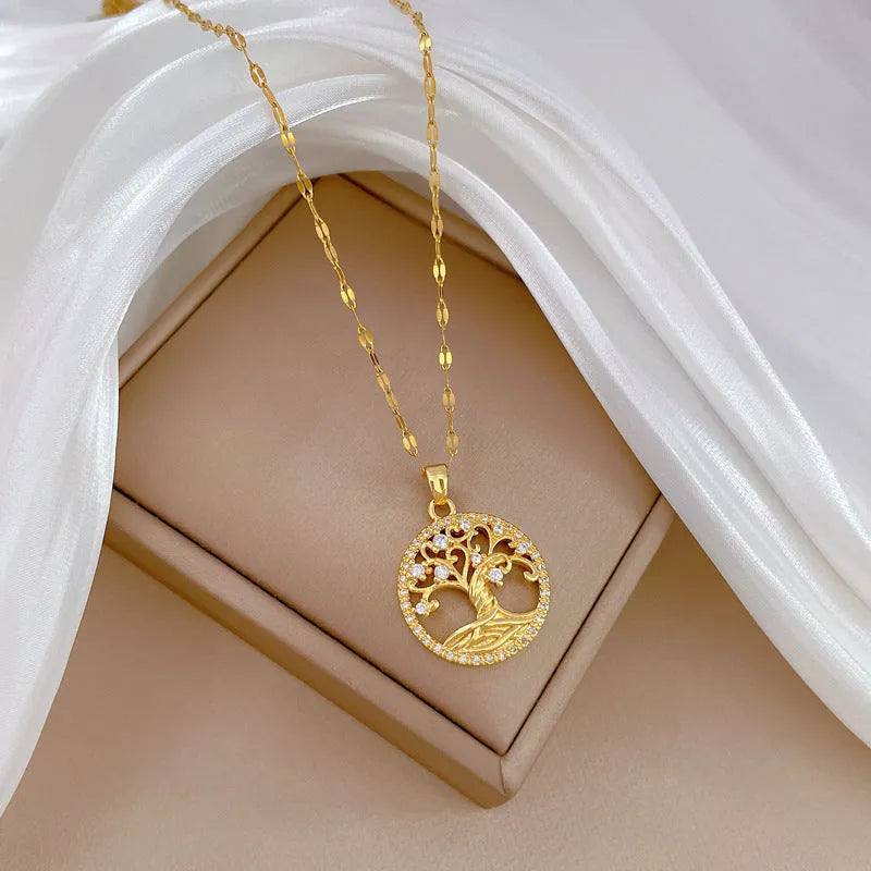 Gold-plated cross necklace with rhinestone lucky tree pendant and mother pearl detail on adjustable 41-50cm chain