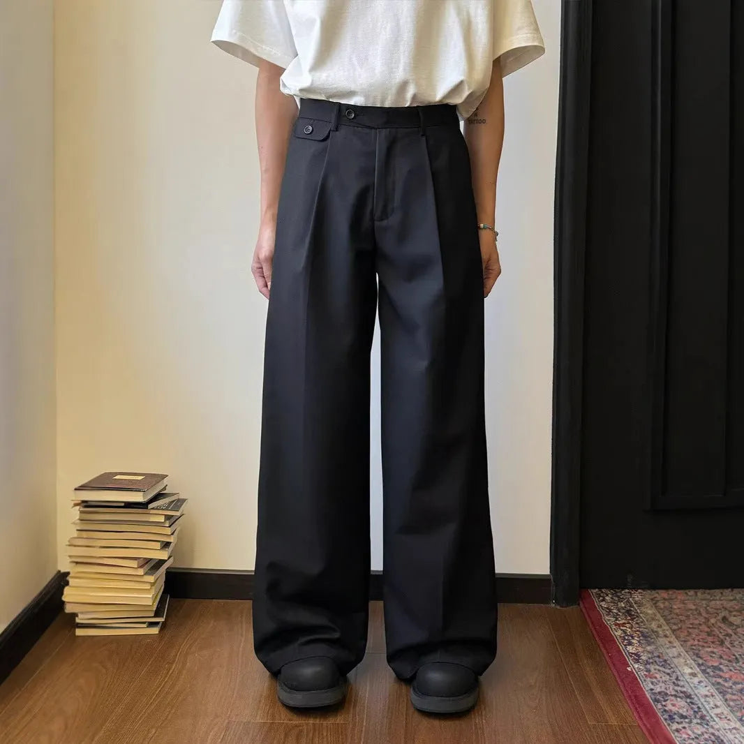 Brown men's straight-leg loose-fit suit trousers laid flat, showing wide-leg drape style.
