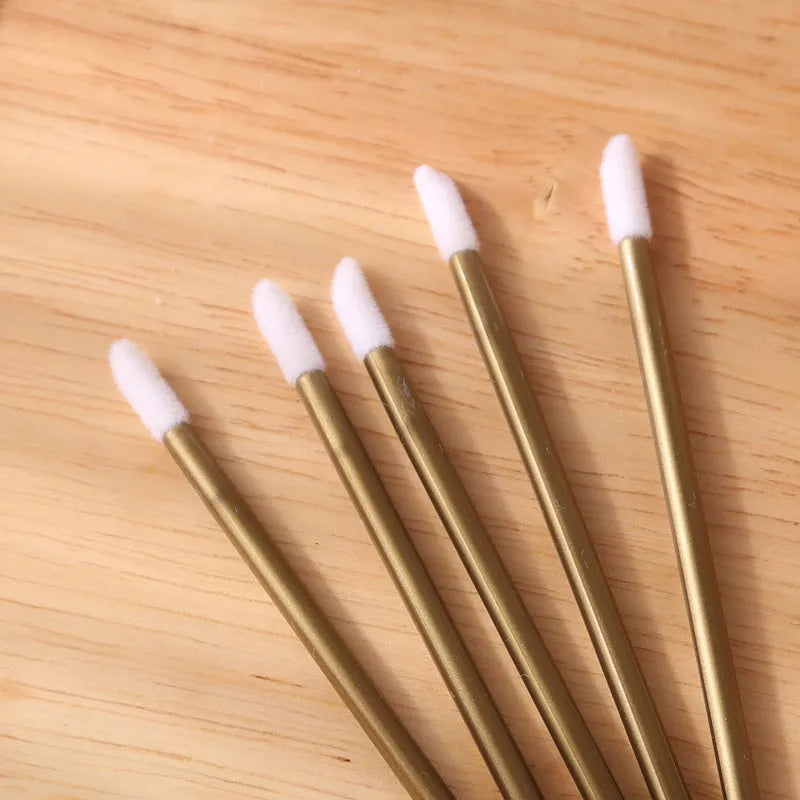 Disposable lip brushes with black handles and flocked tips in bulk packaging for lipstick and gloss application