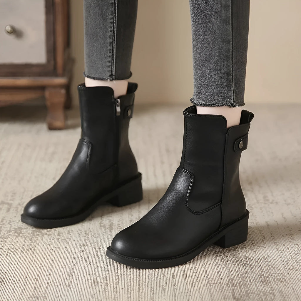 Black women's low heel ankle boots with side zip and round toe on a rubber sole