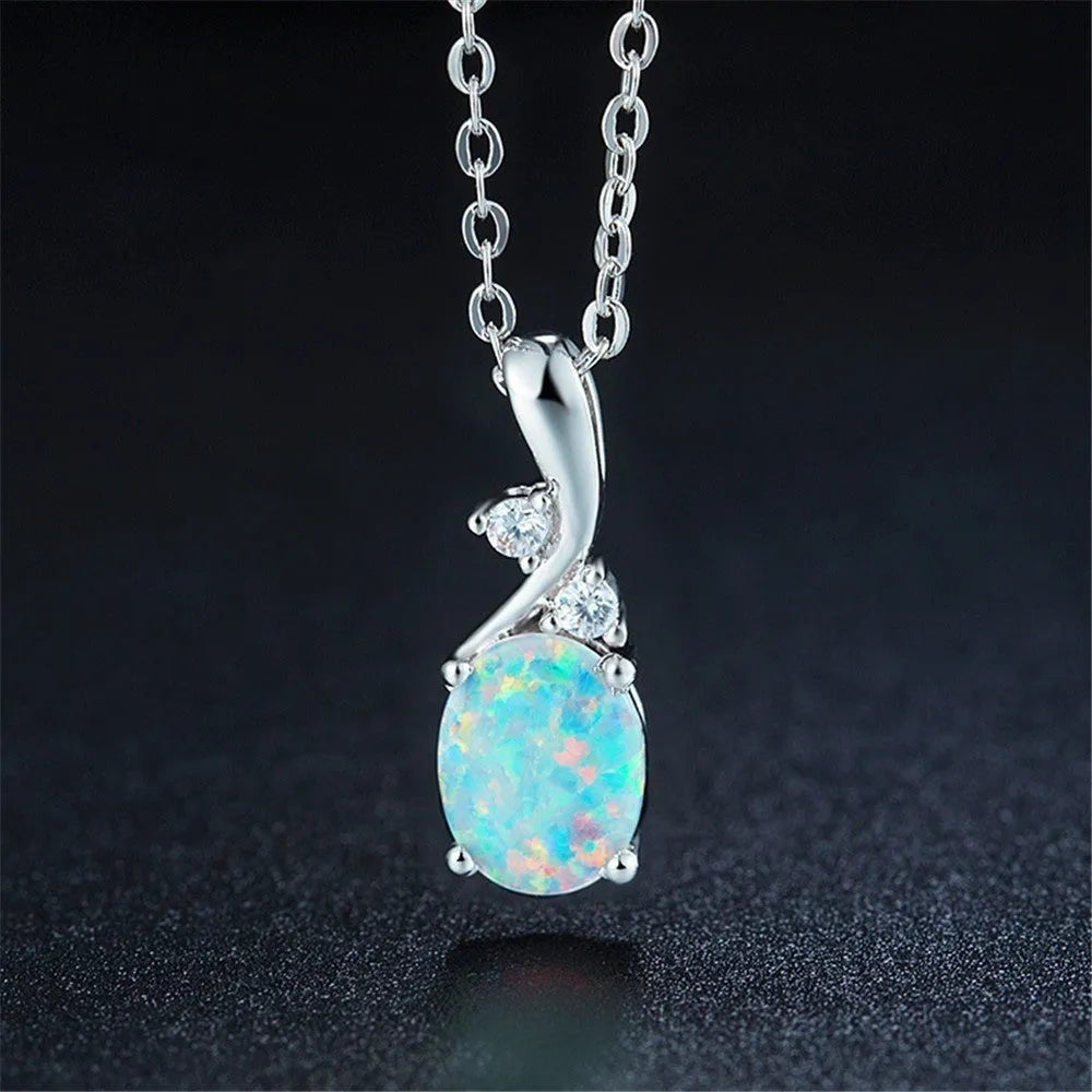 Water drop shaped opal pendant on an adjustable silver tone necklace chain