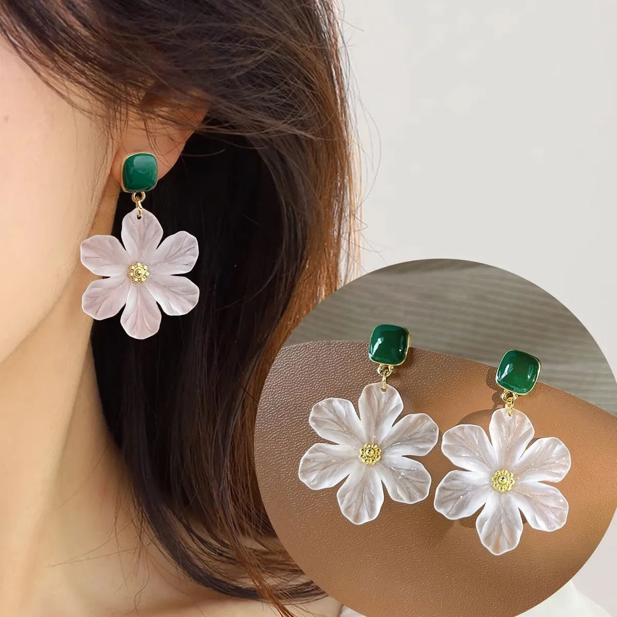 A pair of dark green and alloy needle flowers design drop earrings for women.