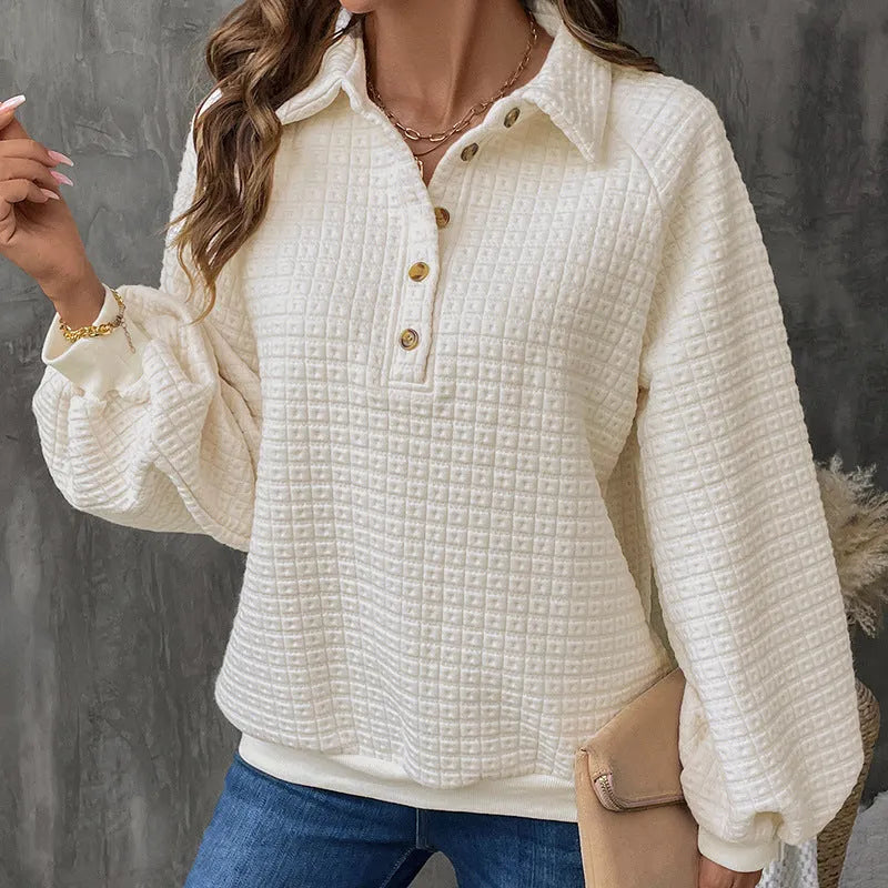 Beige women's knitted sweater with a polo collar and long sleeves laid flat.