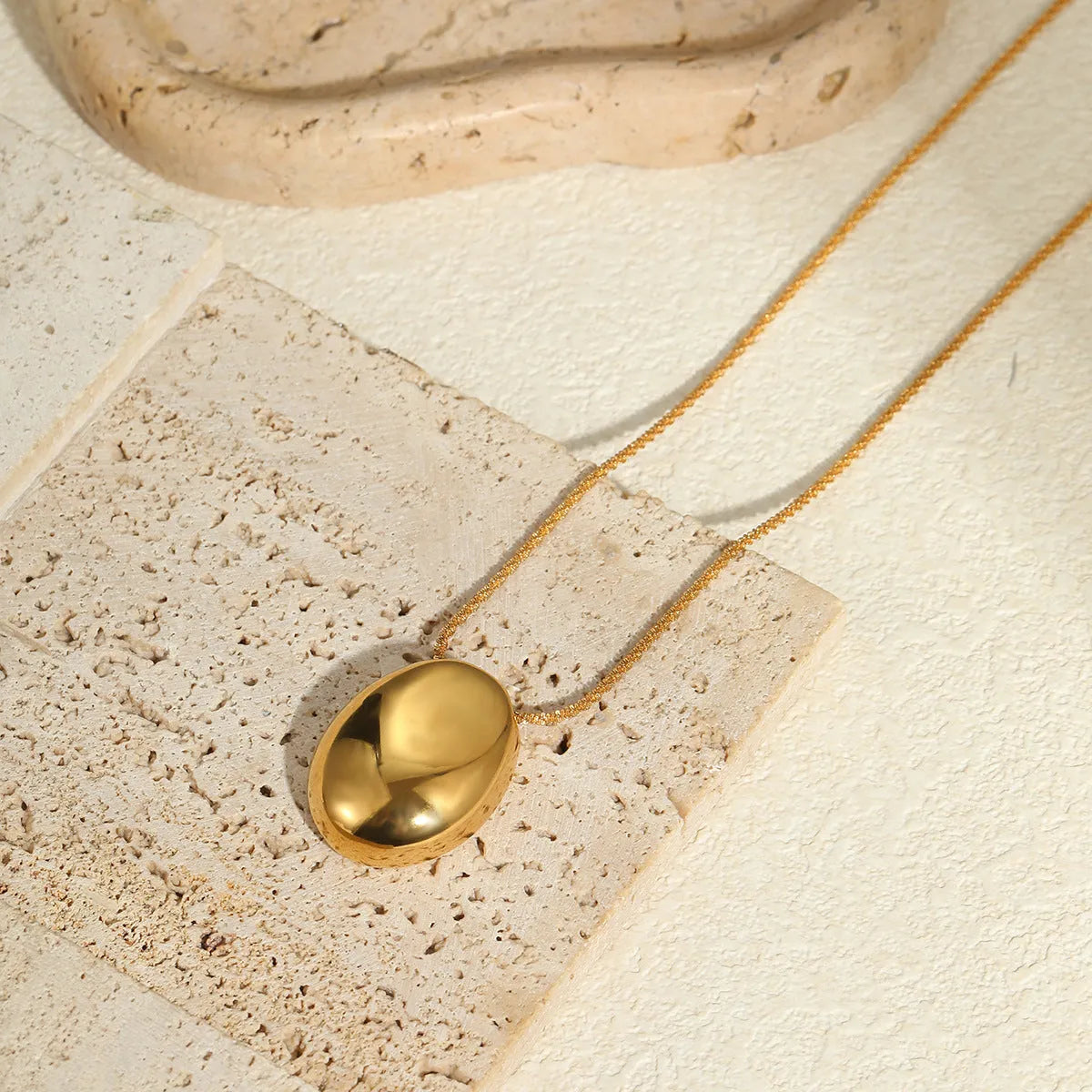Gold geometric pendant necklace with 41-50cm chain on stainless steel background