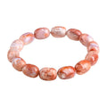 Natural cherry agate barrel bead bracelet with Ruyi design elements on wrist