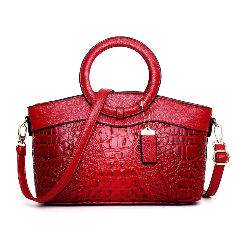 Brown fabric women's handbag showing front zipper compartment and internal organiser pockets.