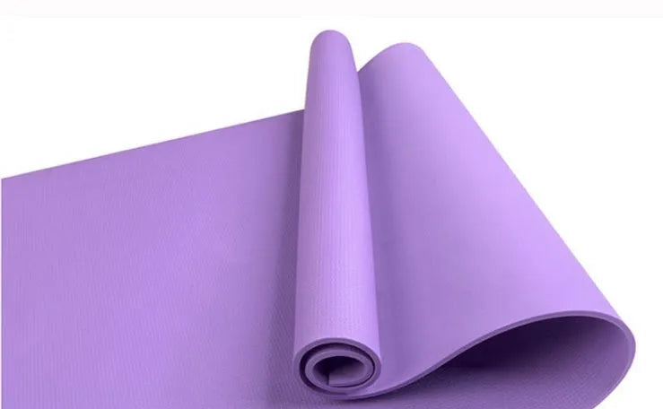 Red EVA fitness yoga mat showing texture and thickness, rolled partially with carry bag.