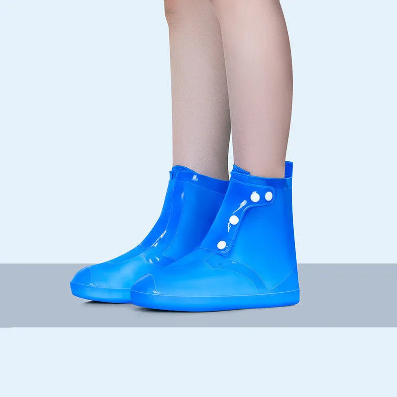 White PVC high-top reusable shoe covers for women, shown on a shoe for rainy day outdoor protection.