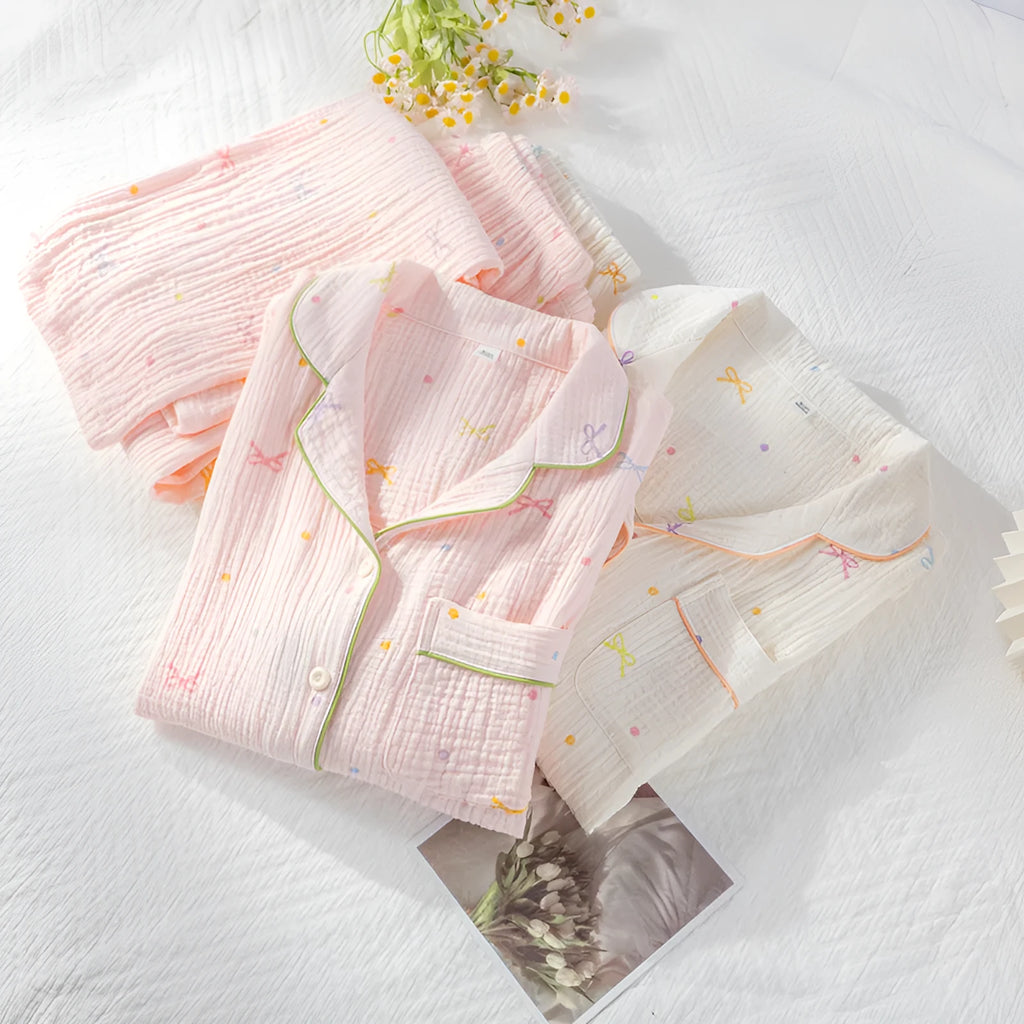 Women's beige cotton pajama set with long sleeves and full-length trousers for home lounging.