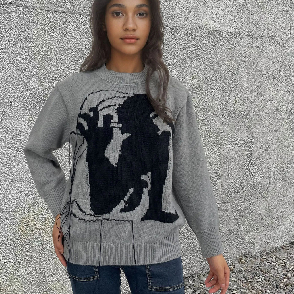 Women's loose grey alpaca wool sweater with tassel detailing and abstract pattern