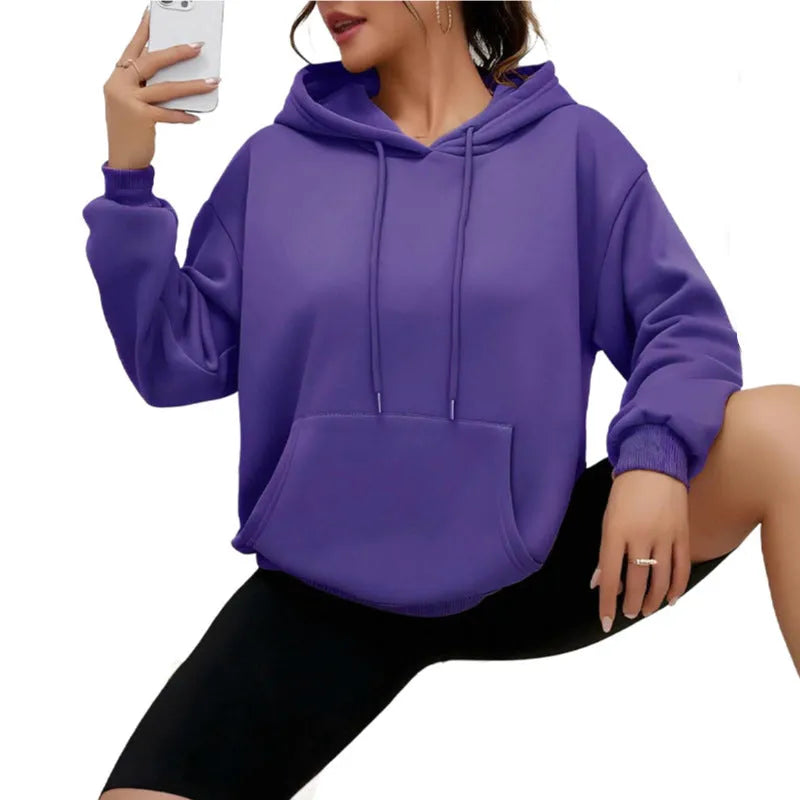 Women's loose fit grey hooded sweatshirt with drawstring and front pocket, long sleeves.