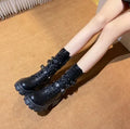 Women's black mid-calf knight boots with metal buckle and side zipper on a round toe.