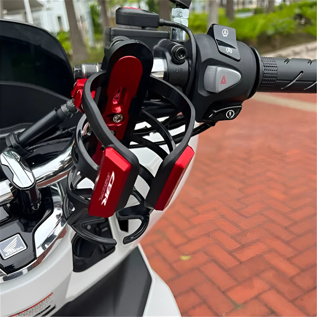 Black water bottle cage mounted on the bumper of a Honda X-ADV scooter