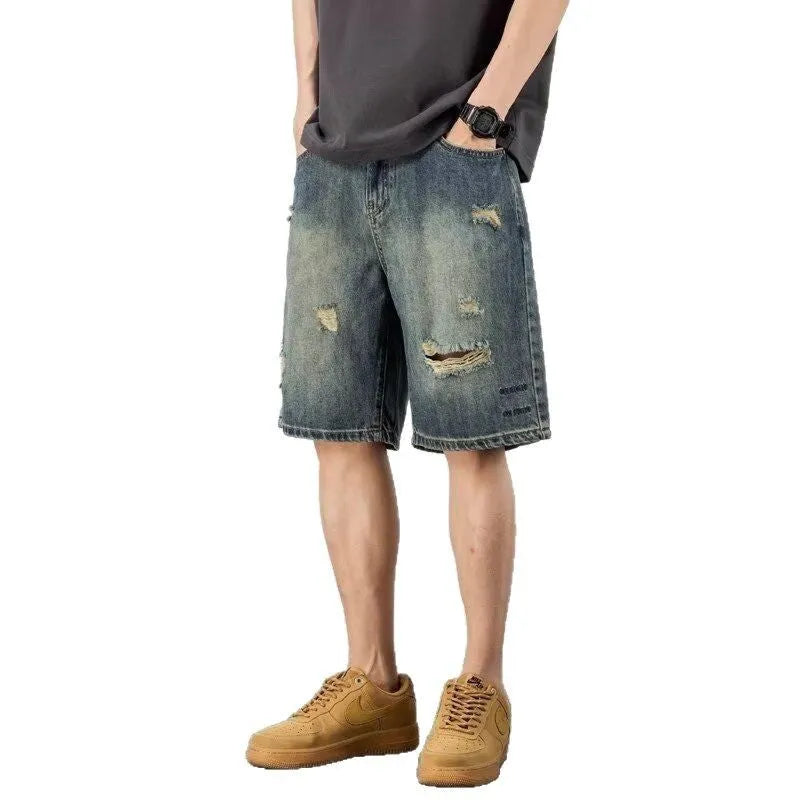Retro blue denim men's shorts with distressed holes and straight leg cut on mannequin