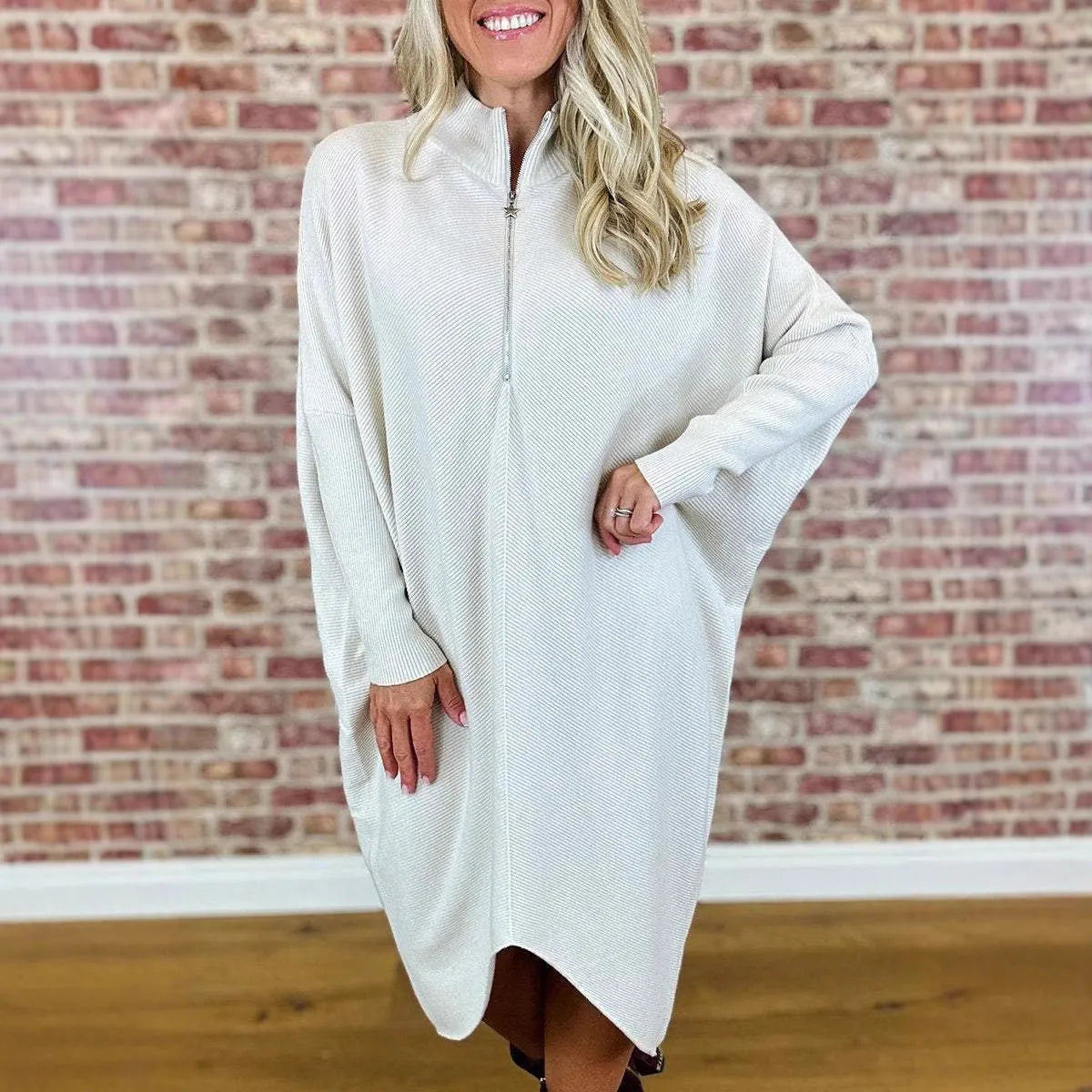 Women's solid colour loose knitted dress with raglan sleeves on a hanger