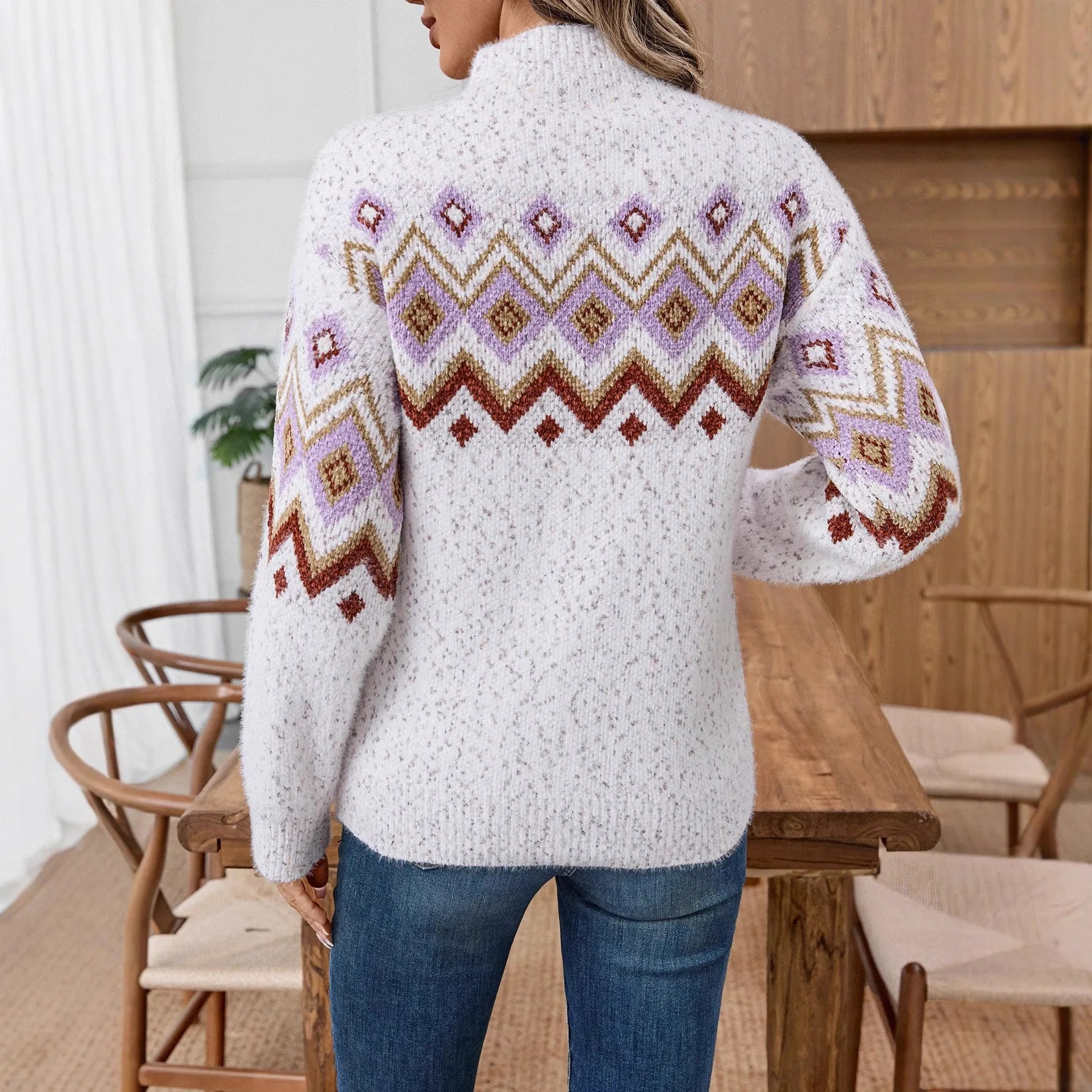 White half turtleneck jacquard sweater with geometric pattern and loose fit.