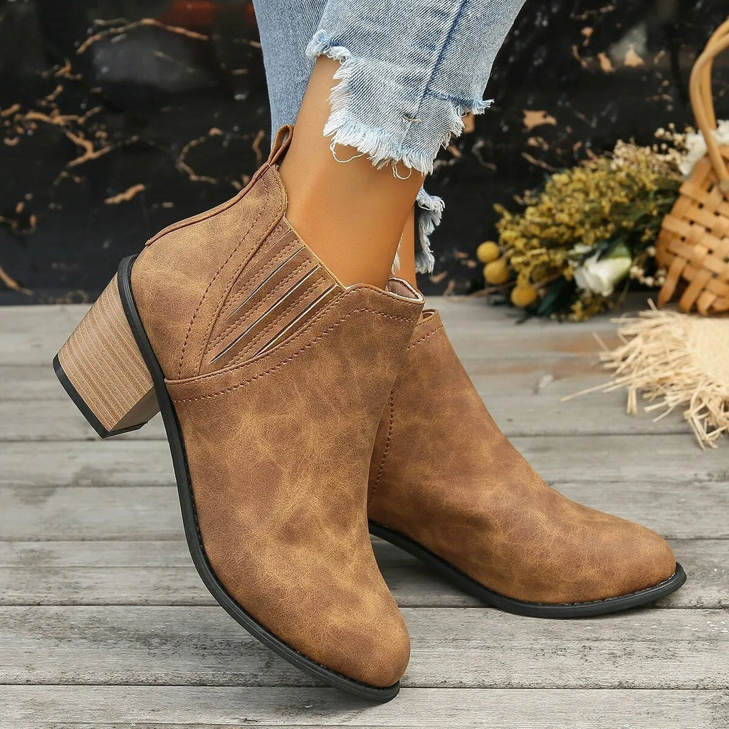 Women's black pointed toe ankle boots with thick square heel and slip-on design