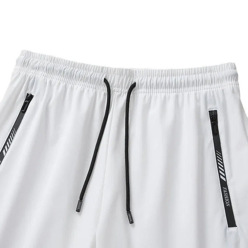 Men's quick-drying nylon sports shorts in black, loose fit with fifth pants length