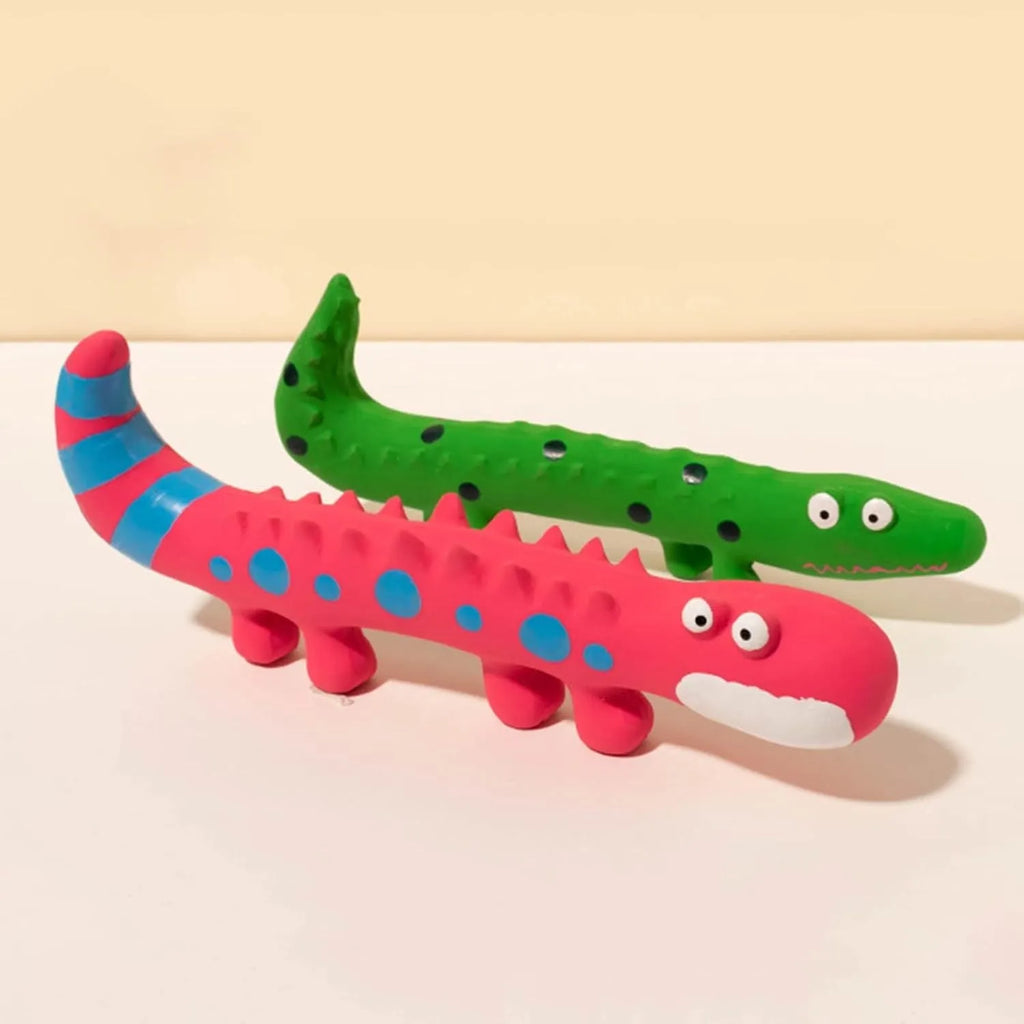 Green cartoon lizard-shaped latex dog chew toy with squeaker on a white background.